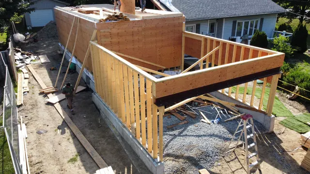 Aerial view of a new addition’s walls framed off the side of the house